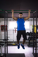 Image showing man doing pull ups on the horizontal bar