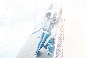 Image showing Pretty Businesswomen Using Tablet In Office Building during conf