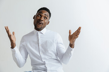 Image showing Portrait of excited young African American male screaming in shock and amazement.