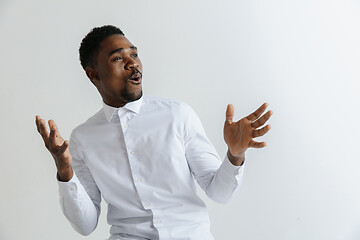 Image showing Portrait of excited young African American male screaming in shock and amazement.