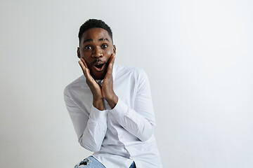 Image showing Portrait of excited young African American male screaming in shock and amazement.