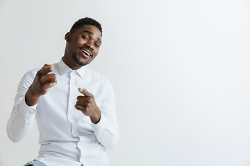 Image showing Afro american man over isolated grey background pointing with finger to the camera and to you, hand sign, positive and confident gesture from the front