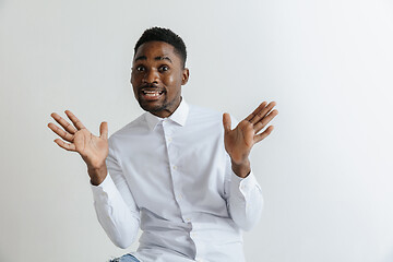 Image showing Closeup portrait of handsome young man shocked surprised, open mouth and eyes, mad by what he sees, isolated on grey background. Negative human emotion facial expression feeling concept.