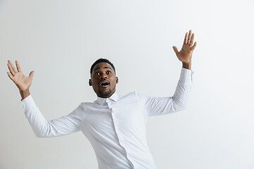 Image showing Portrait of excited young African American male screaming in shock and amazement.