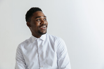 Image showing Close up portrait of a happy young african american man laughing against gray background.