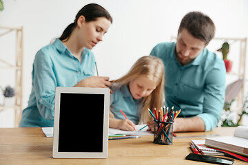 Image showing Young happy family are spending time together. A day with loved ones at home.