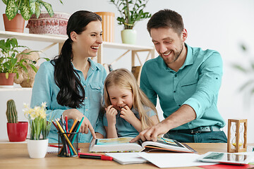 Image showing Young happy family are spending time together. A day with loved ones at home.