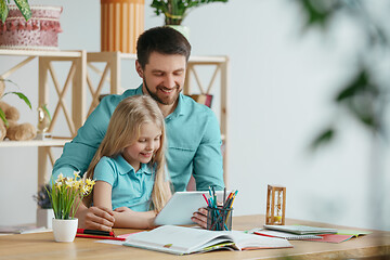 Image showing Young happy family are spending time together. A day with loved ones at home.