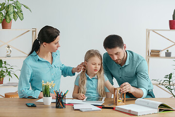 Image showing Young happy family are spending time together. A day with loved ones at home.