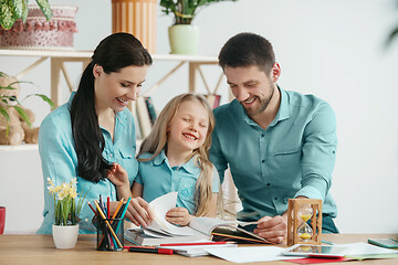 Image showing Young happy family are spending time together. A day with loved ones at home.