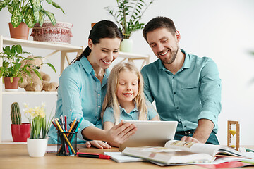 Image showing Young happy family are spending time together. A day with loved ones at home.