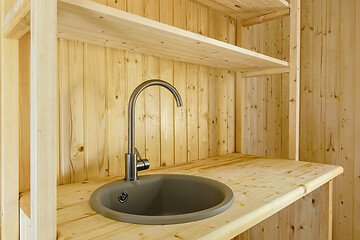 Image showing Kitchen set in a country house, worktop and walls made of natural wood