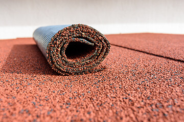 Image showing On the roof covered with roll tiles, there is a residue in a roll