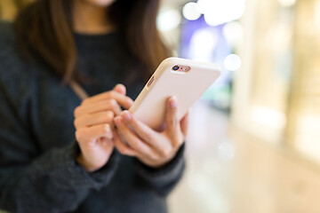 Image showing Woman sending sms on mobile phone