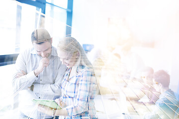 Image showing Two Business People Working With Tablet in office