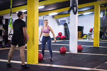 Image showing young athletes couple working out with medical ball