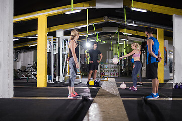 Image showing athletes doing exercises with kettlebells