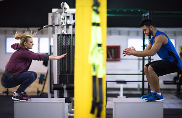 Image showing athletes working out  jumping on fit box