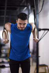 Image showing man working out pull ups with gymnastic rings