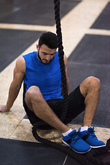 Image showing man relaxing before rope climbing