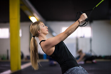 Image showing woman working out pull ups with gymnastic rings