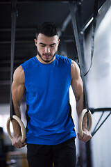 Image showing man working out pull ups with gymnastic rings