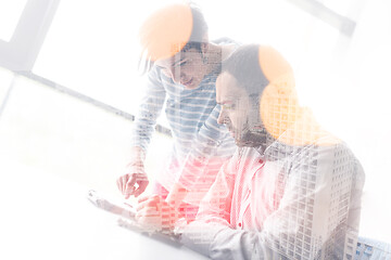 Image showing Two Business People Working With Tablet in startup office