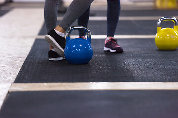 Image showing athletes doing exercises with kettlebells