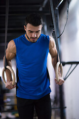 Image showing man working out pull ups with gymnastic rings