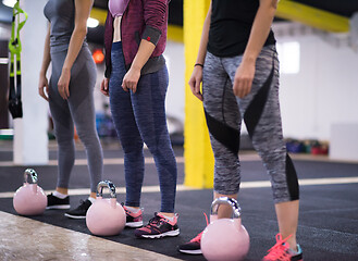 Image showing athletes doing exercises with kettlebells