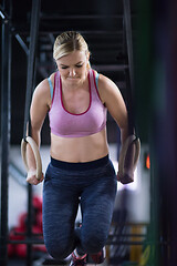 Image showing woman working out pull ups with gymnastic rings