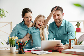 Image showing Young happy family are spending time together. A day with loved ones at home.