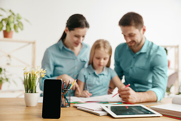 Image showing Young happy family are spending time together. A day with loved ones at home.