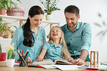 Image showing Young happy family are spending time together. A day with loved ones at home.