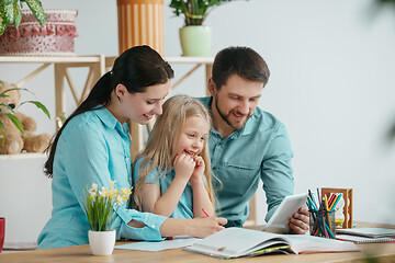 Image showing Young happy family are spending time together. A day with loved ones at home.