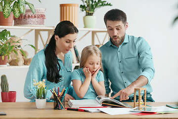 Image showing Young happy family are spending time together. A day with loved ones at home.