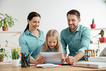 Image showing Young happy family are spending time together. A day with loved ones at home.