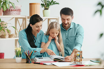 Image showing Young happy family are spending time together. A day with loved ones at home.