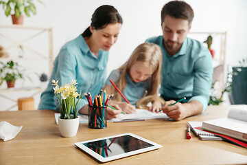 Image showing Young happy family are spending time together. A day with loved ones at home.