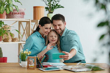 Image showing Young happy family are spending time together. A day with loved ones at home.