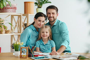 Image showing Young happy family are spending time together. A day with loved ones at home.