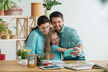 Image showing Young happy family are spending time together. A day with loved ones at home.