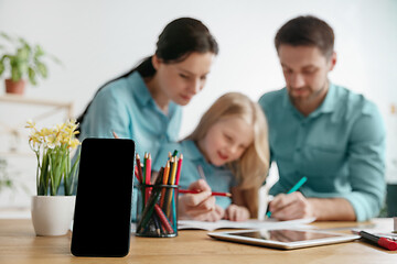 Image showing Young happy family are spending time together. A day with loved ones at home.