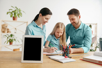 Image showing Young happy family are spending time together. A day with loved ones at home.