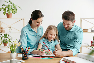 Image showing Young happy family are spending time together. A day in lovely home.