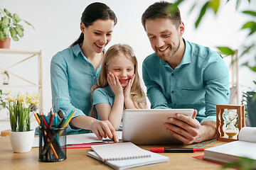 Image showing Young happy family are spending time together. A day with loved ones at home.