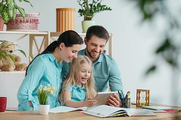 Image showing Young happy family are spending time together. A day with loved ones at home.