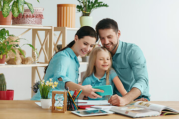 Image showing Young happy family are spending time together. A day with loved ones at home.