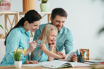 Image showing Young happy family are spending time together. A day with loved ones at home.