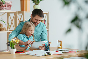 Image showing Young happy family are spending time together. A day with loved ones at home.